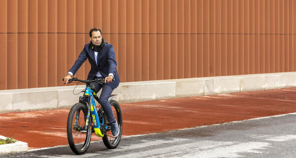 Man in suit riding an electric bike